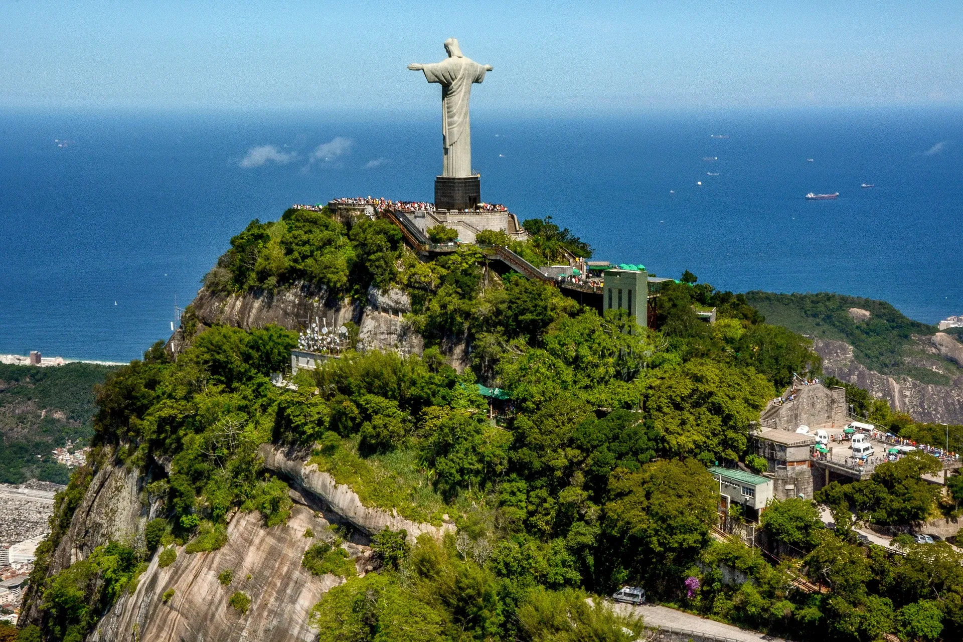 Christ the Redeemer overlooking Rio de Janeiro with Sugarloaf Mountain in the distance