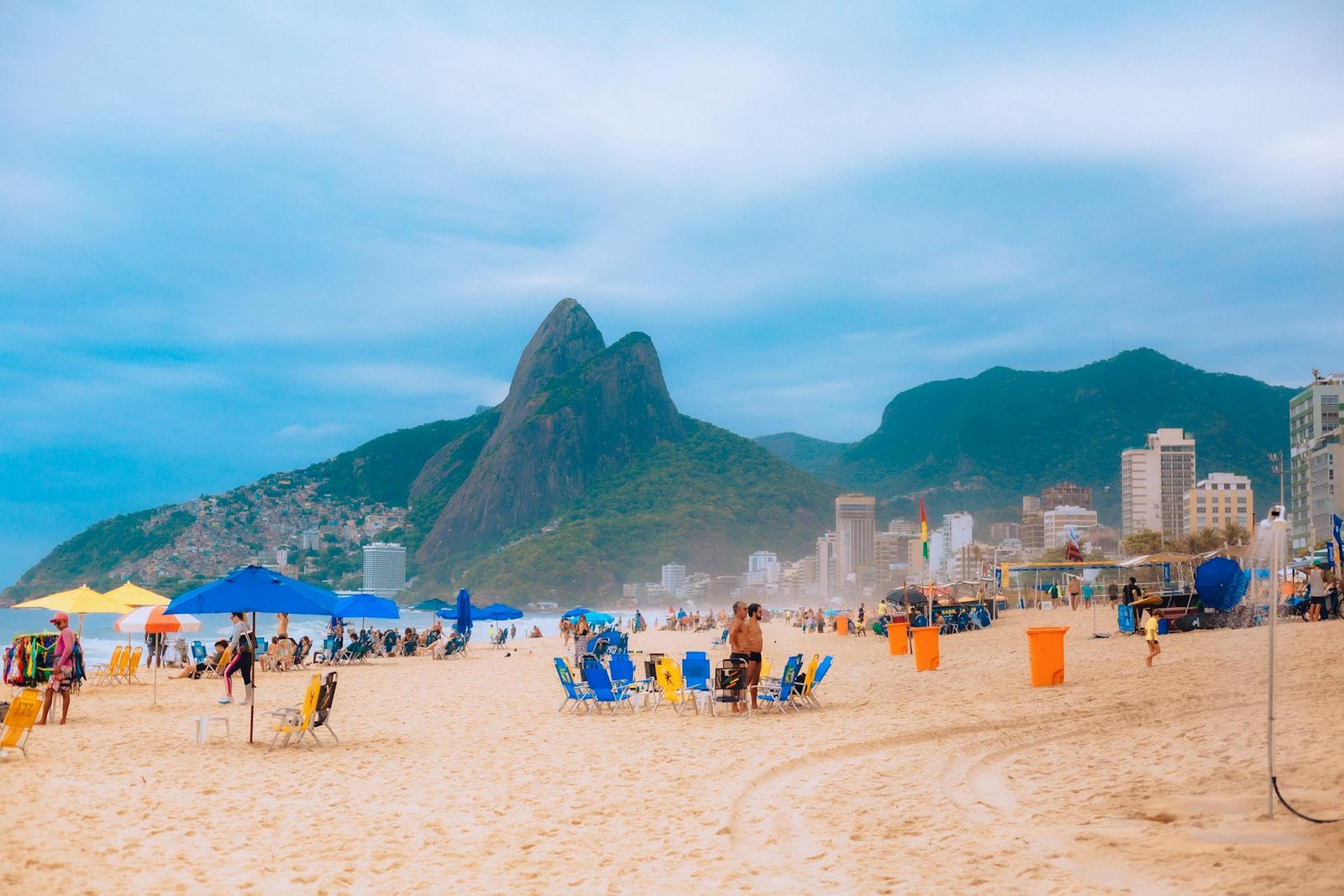 Ipanema beach scene with people walking, playing sports, and relaxing