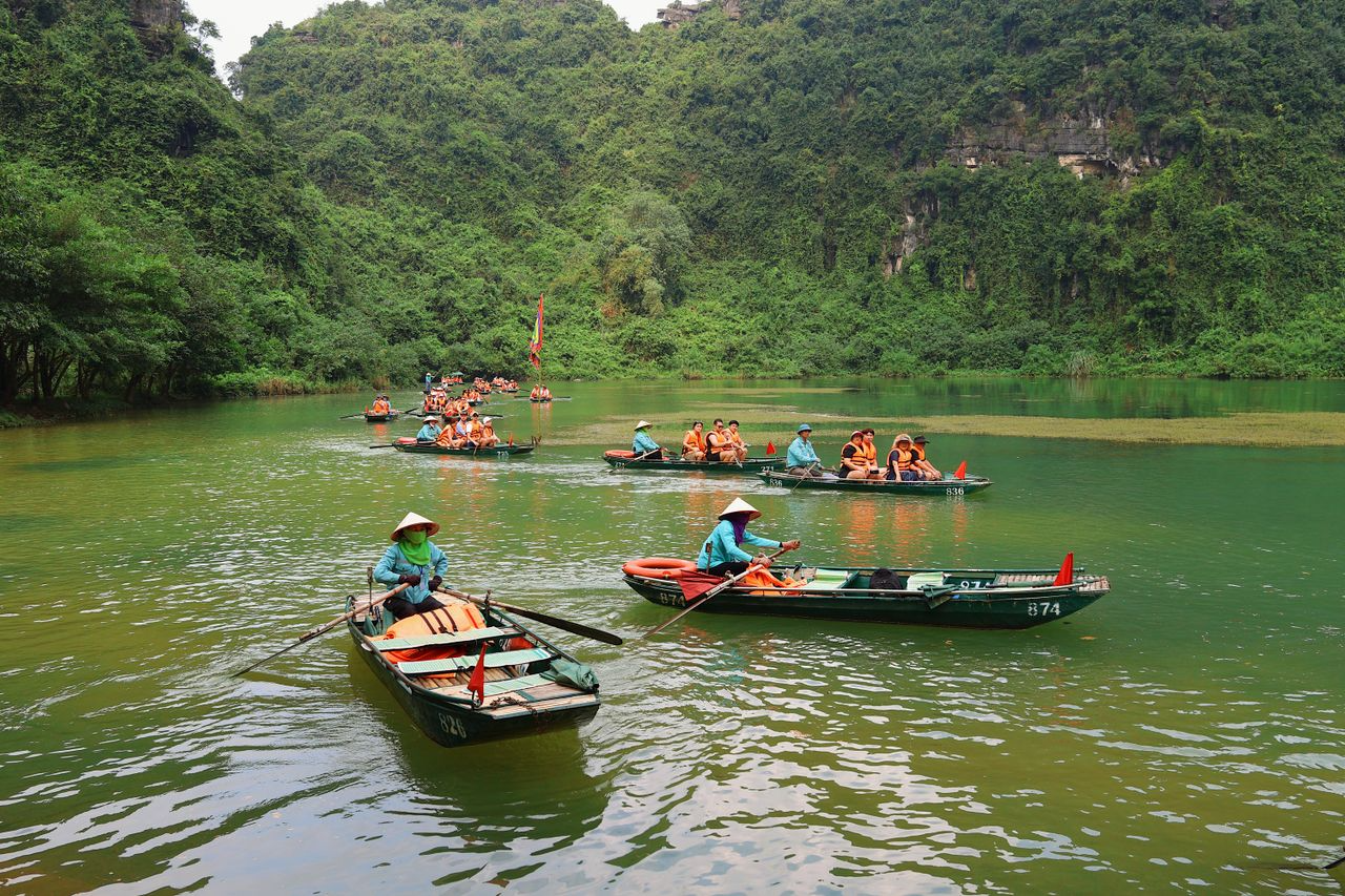 Sampan boats at Trang An in Ninh Binh, where the 2026 boat tour ticket costs 300,000 VND per person